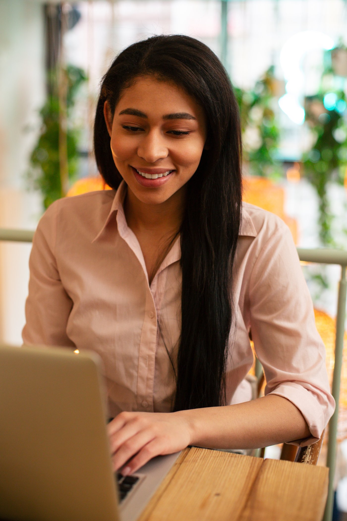 A Seeker with a laptop, smiling - clarity after the conversation, moving forward.